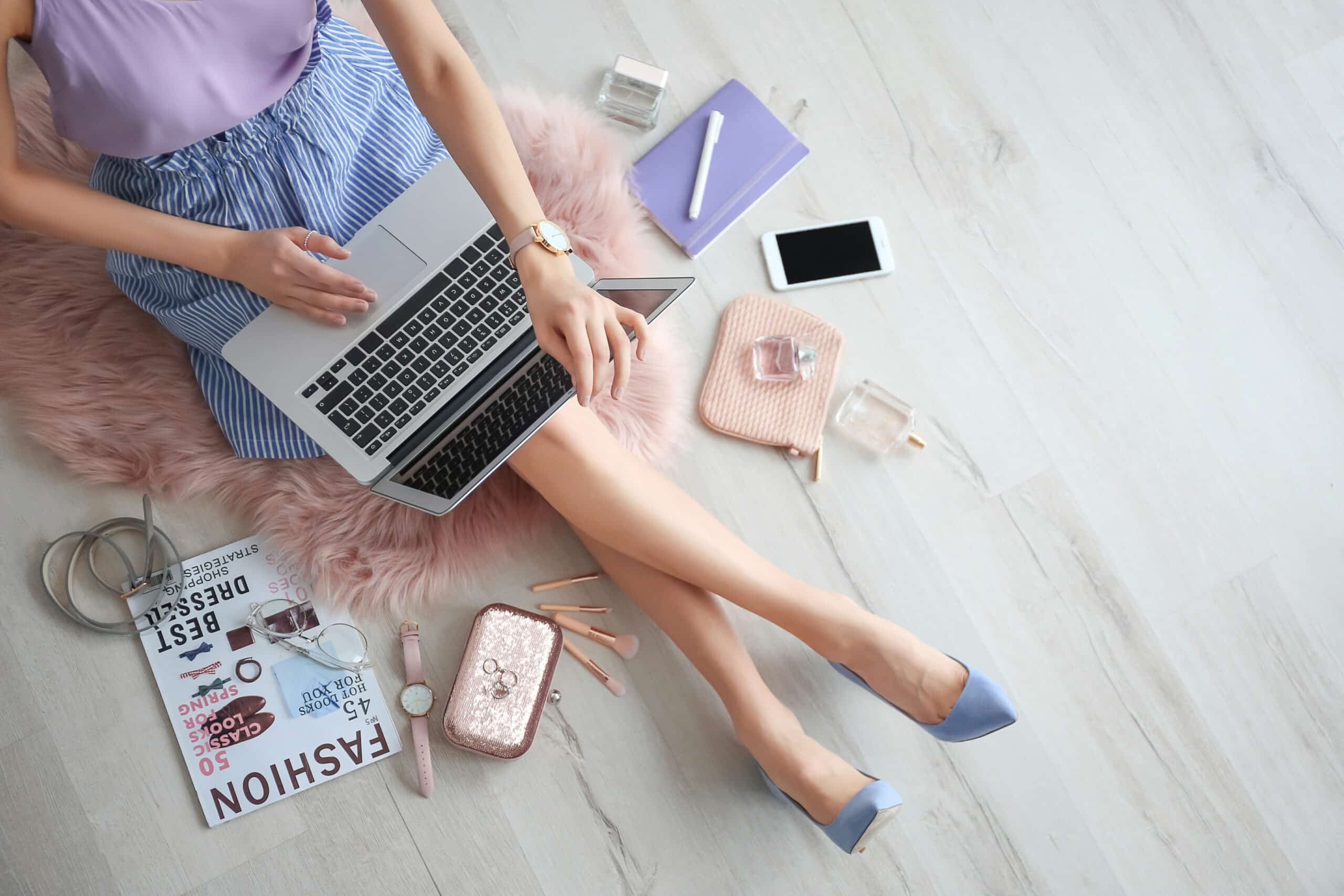 Female beauty blogger with laptop indoors, top view